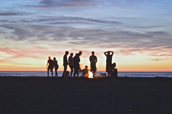 adult backlit beach child coast evening group men