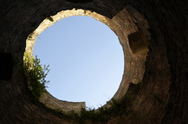 round sky through ancient fortress wall