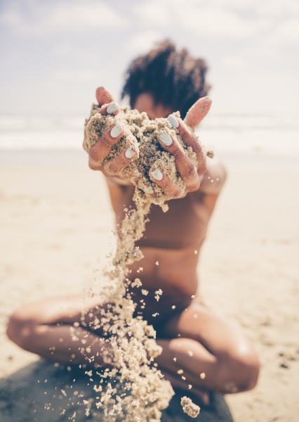 attractive girl playing with sand
