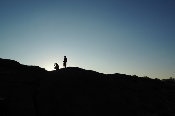 backlit cross desert dusk evening hiking hill