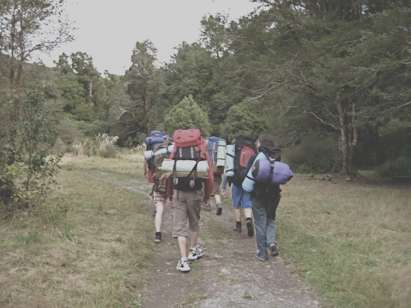 backpackers walking down trail
