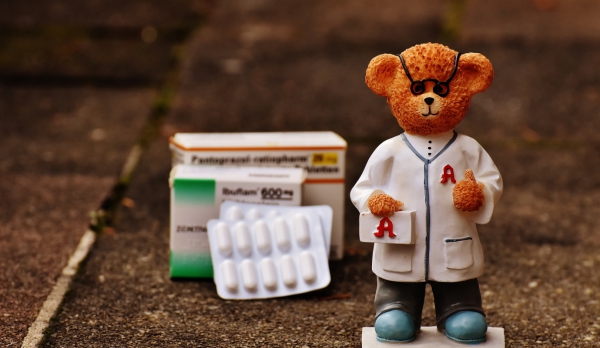 closeup of toddler bear near medicine