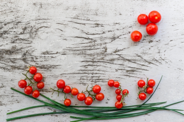 small red tomatoes on wooden background