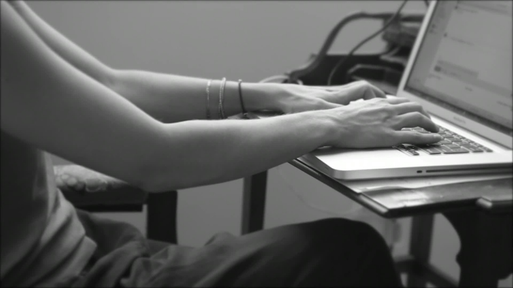 black white clip of woman typing on laptop