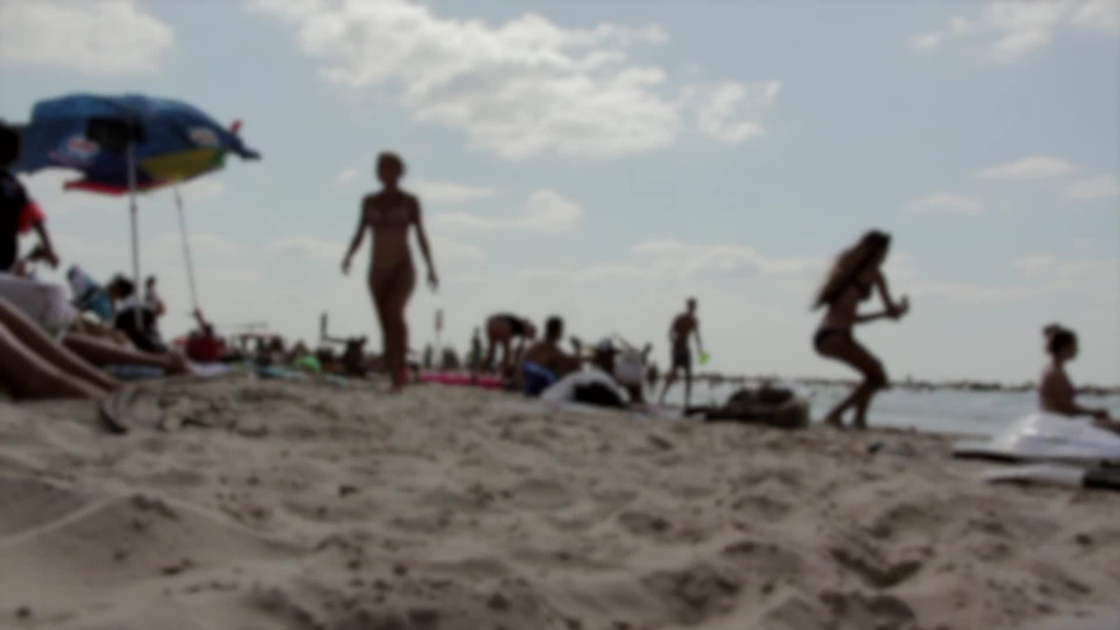 blurred clip of crowded beach in summer