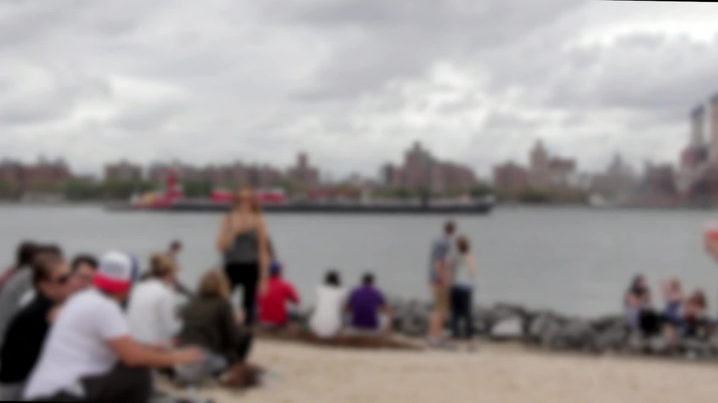blurred video of crowd relaxing on sea bay