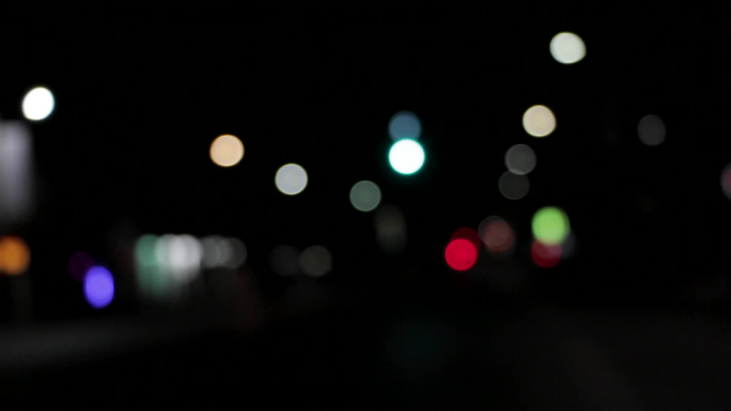 bokeh clip of colorful lights in darkness
