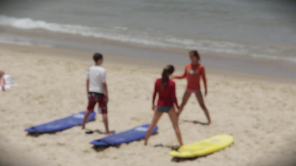 bokeh clip of youth doing exercise on beach