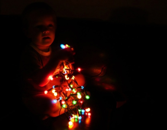 child and christmas lights
