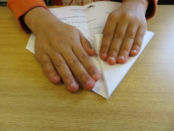 child's hand paper airplane art