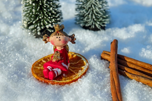 cute decorative doll on snow