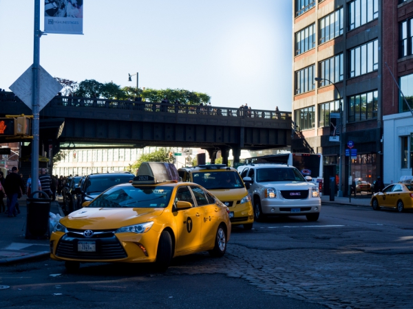 city buildings and street with taxi