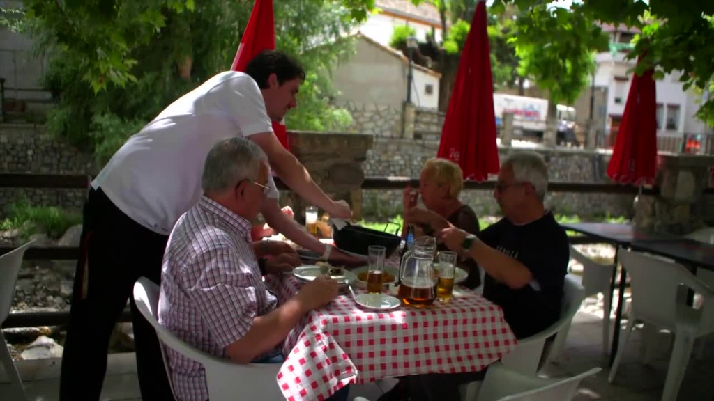 clip of outdoor lunch gathering with traditional cuisine