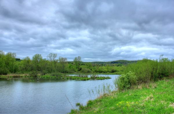 cloudy skies over pond at kickapoo valley reserve wisconsin