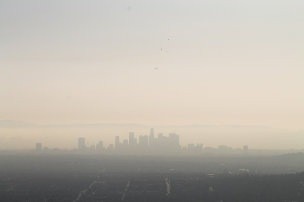 distant downtown city buildings in smog