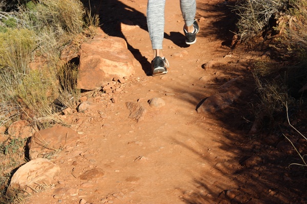feet walking on dirt path