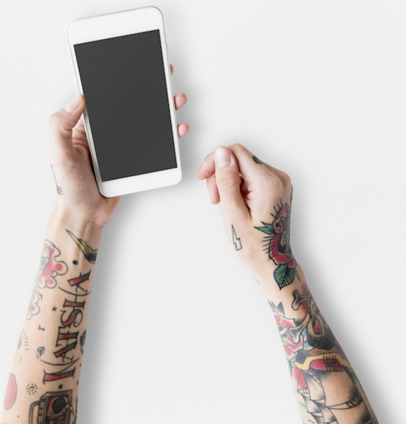 free hand with tattoos using mobile phone mockup