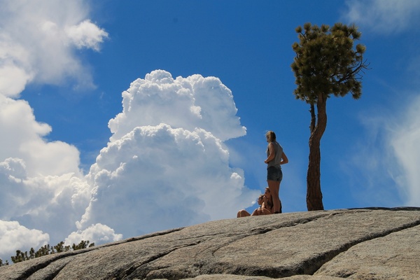 girls on rock with clouds