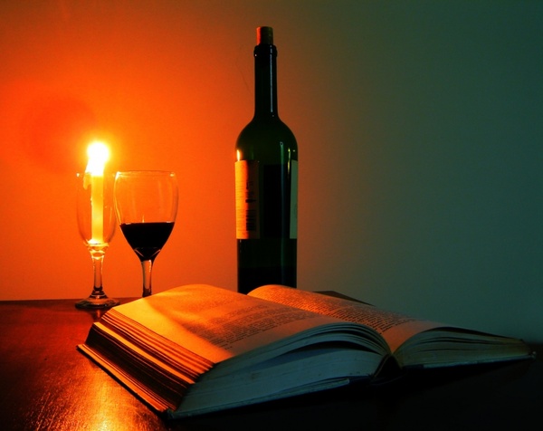 glass of wine book candle 