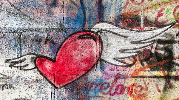 heart wing painting on grunge wall