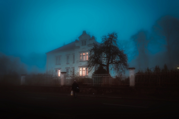 man in front of house covered by fog 