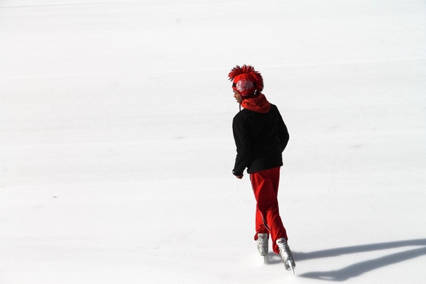 ice skater in black 038 red on ice skating rink