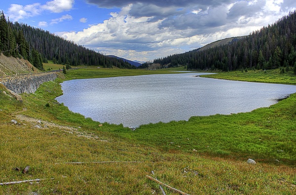 lake trees and clouds at rocky mountains national park colorado