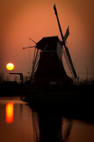landscape with dutch mill at sunset
