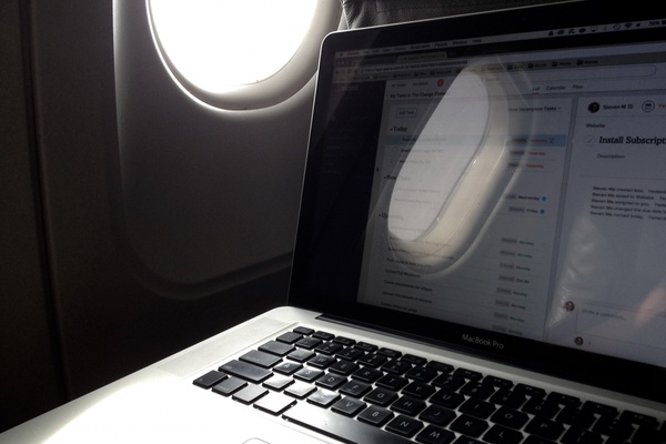 laptop next to airplane window