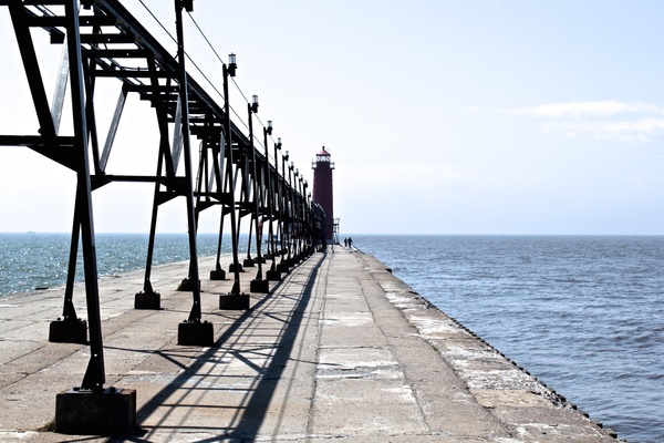 lighthouse at end of pier on lake