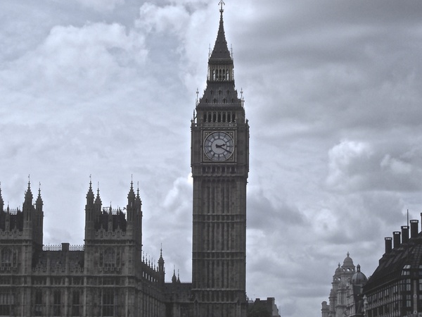 london clock tower against gloomy sky