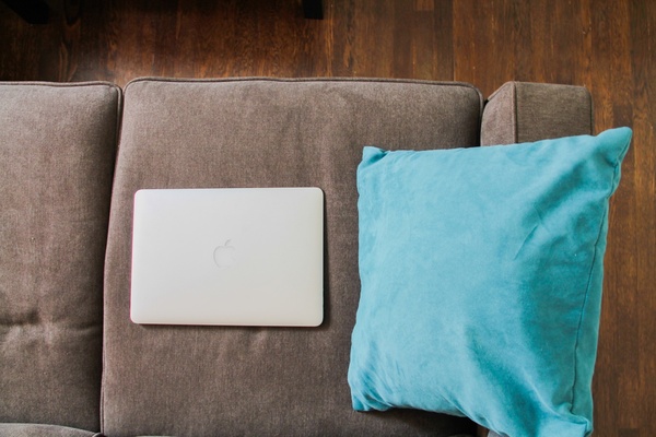 macbook laptop on sofa