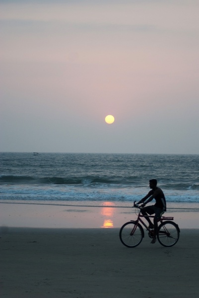 man bicycle beach