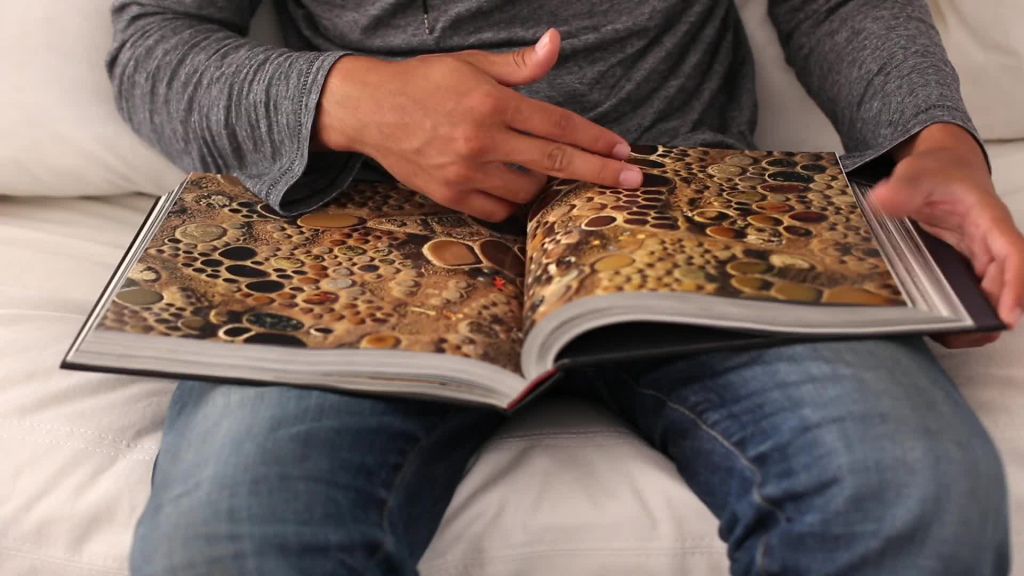 man opening colored pictures book