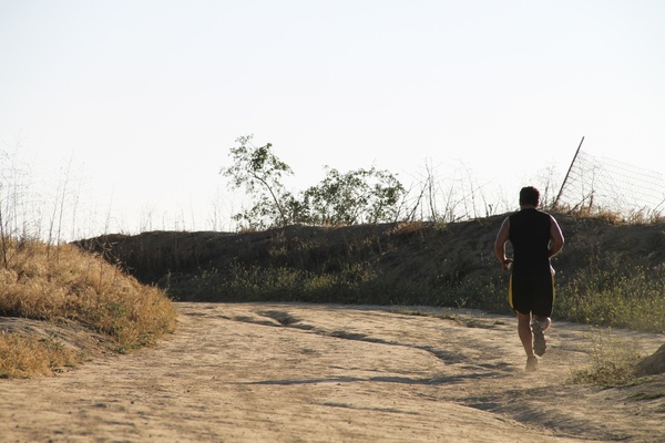 man running on dirt path