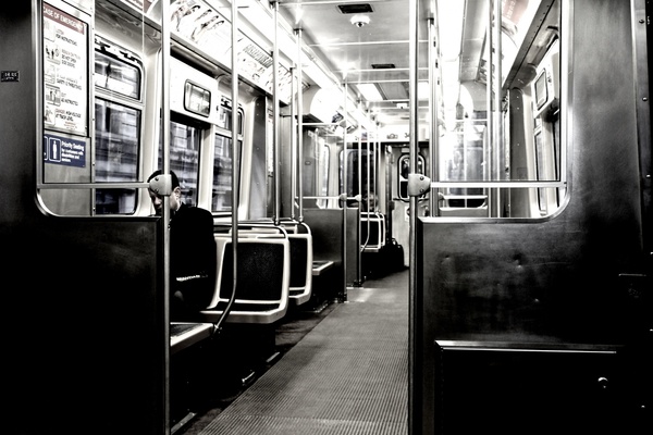 man sitting alone in empty train 