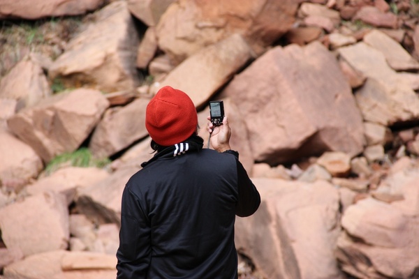 man taking photos of rocks 