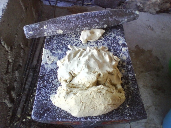 mealing stone and corn dough 