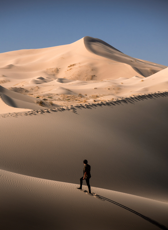 mexico scenery picture man walking on sand dune