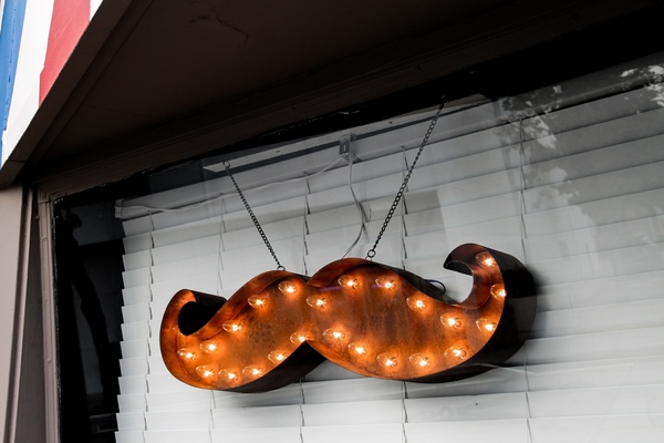 mustache light marquee in window 