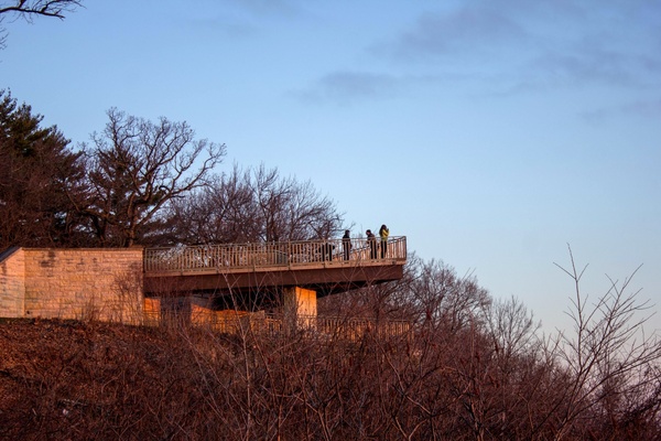 people on the balcony watching the sunrise at pikes peak state park iowa