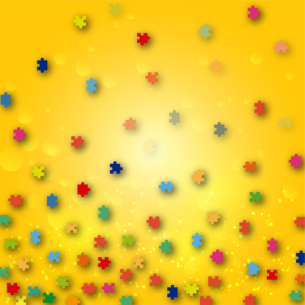 pieces of coloured jigsaw puzzle on yellow background