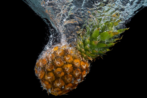 pineapple splashes into the water