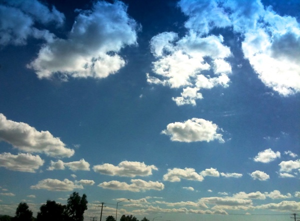 puffy white clouds in blue sky