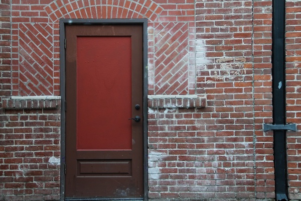 red 038 brown door on brick building