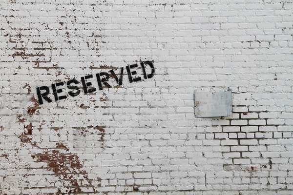 reserved painted on white brick wall