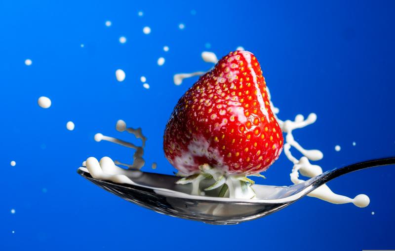 strawberry milk backdrop picture dynamic splashing droplet spoon closeup 
