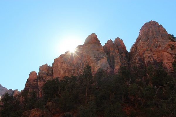sun rising over jagged rock mountains