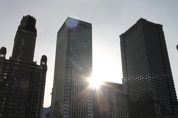 sun shining through 3 skyscraper buildings