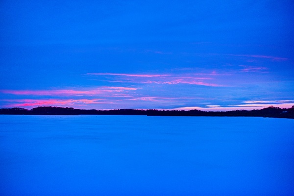 sunset and dusk over frozen rock lake wisconsin 